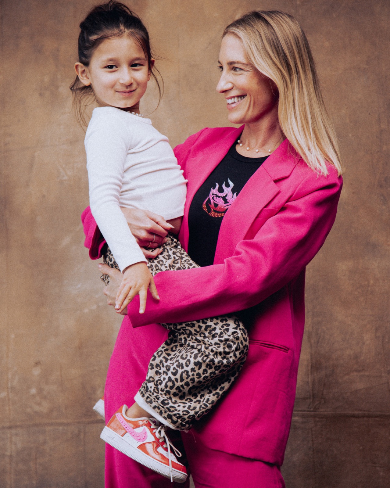 Mother in a pink suit lifting her daughter, Astral Mother's Day campaign